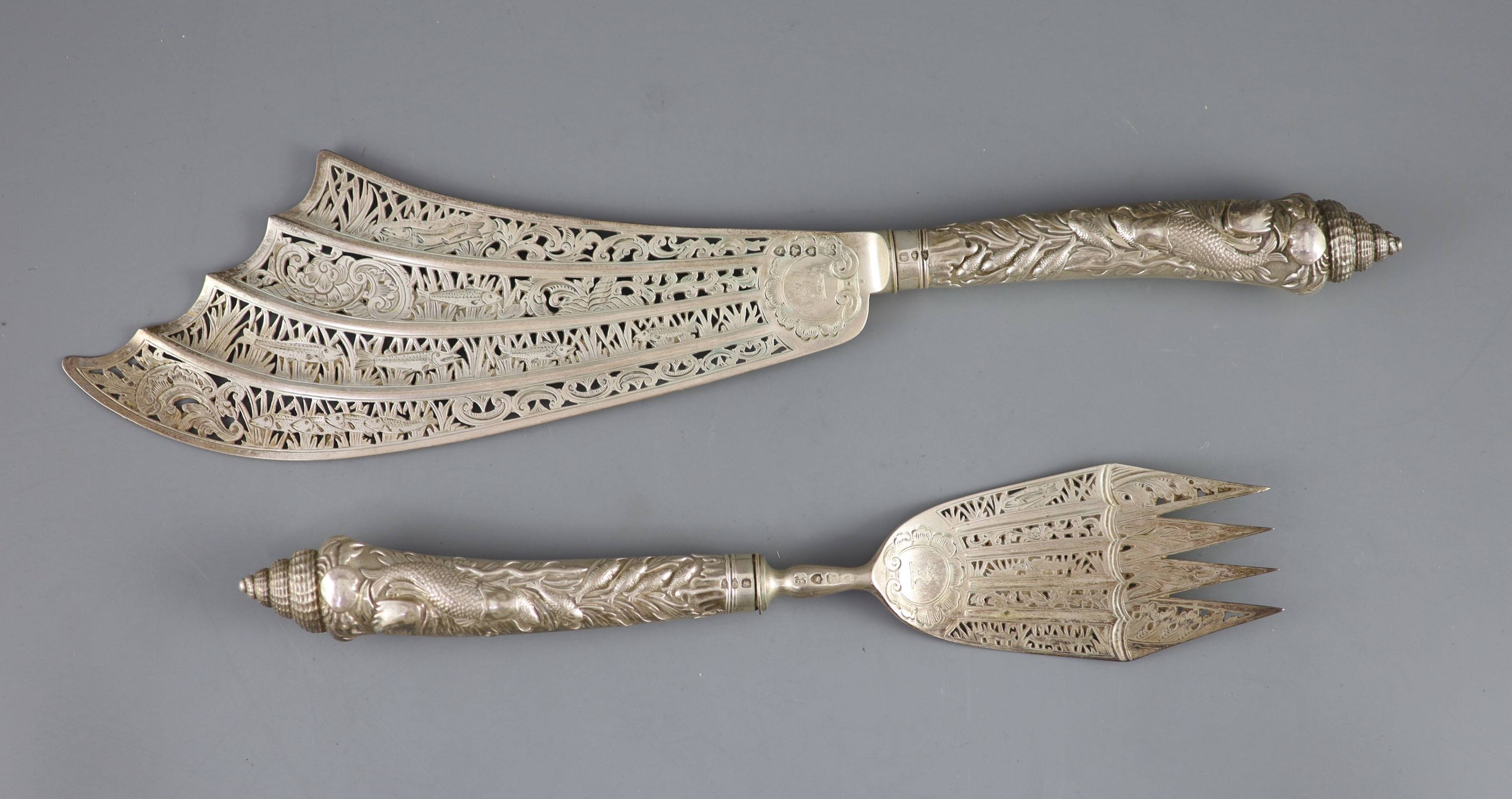 A cased ornate pair of Victorian silver fish servers, Aldwinckle & Slater